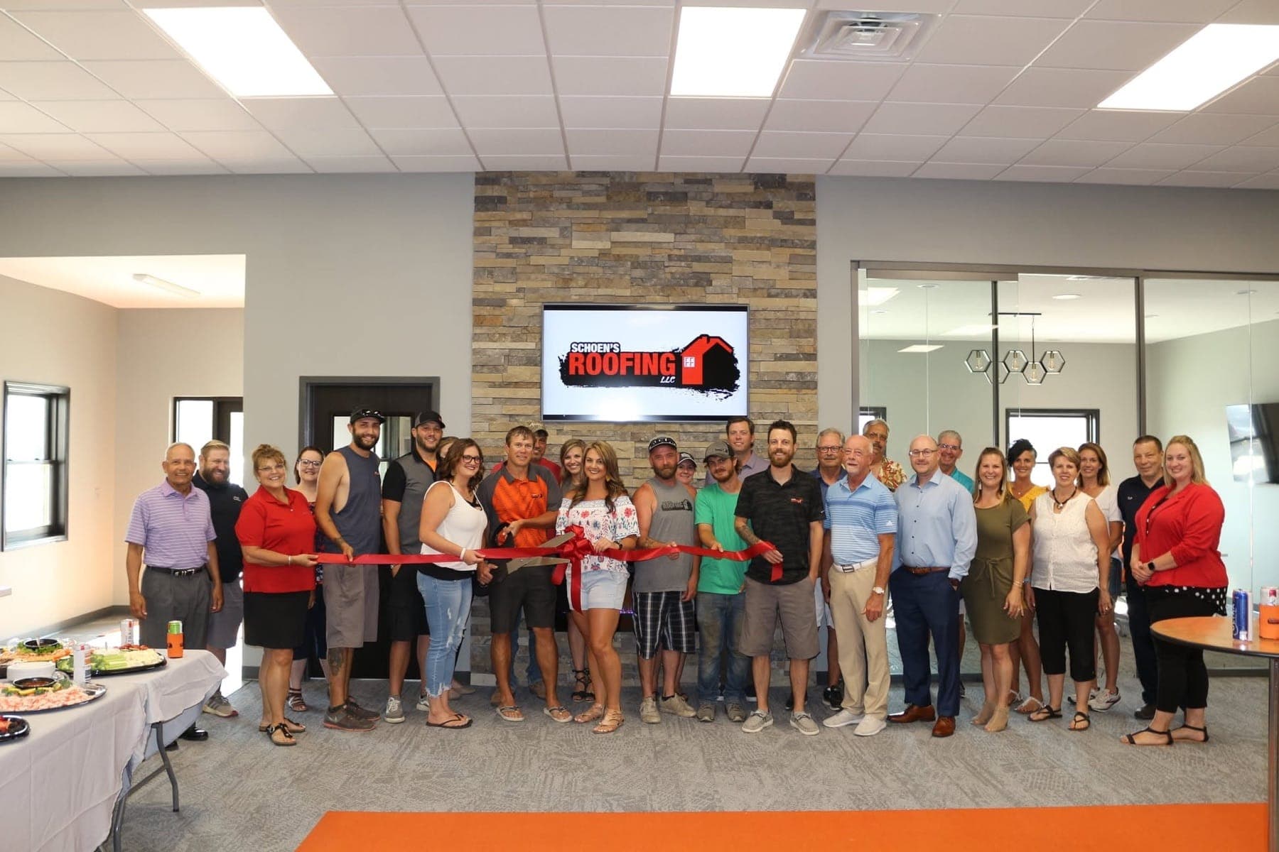 The Schoen's Roofing team gathered for the grand opening of their office